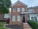 Charming brick townhome featuring a black front door and well-maintained landscaping at 922 Edgewater Cir, Chapel Hill, NC 27516