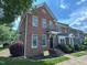 Brick townhome with manicured front lawn, complemented by mature trees and inviting entryway at 922 Edgewater Cir, Chapel Hill, NC 27516