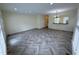 Sunlit living room featuring stylish wood floors, ample space, and a view into the kitchen at 922 Edgewater Cir, Chapel Hill, NC 27516