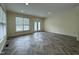 Spacious living room with modern flooring, recessed lighting, and French doors to the outside at 922 Edgewater Cir, Chapel Hill, NC 27516