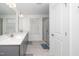 Modern bathroom with double vanity, a glass-enclosed shower and neutral-toned tile at 937 Baldwin Ridge Rd, Apex, NC 27523