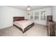 Bright bedroom with ample natural light, a wood-frame bed, and matching dresser at 937 Baldwin Ridge Rd, Apex, NC 27523