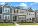 Charming townhome with a covered front porch, stone accents, and a well-maintained lawn at 937 Baldwin Ridge Rd, Apex, NC 27523