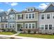 Inviting townhome featuring a stone foundation, neutral siding and a well-maintained lawn at 937 Baldwin Ridge Rd, Apex, NC 27523