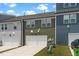 Townhome exterior with green and blue siding, garages and lawns, offering modern lifestyle appeal at 937 Baldwin Ridge Rd, Apex, NC 27523