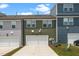 Townhome exterior with green and blue siding, garages and manicured lawns, showcasing modern living at 937 Baldwin Ridge Rd, Apex, NC 27523