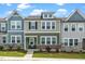 Charming townhome featuring a stone foundation, neutral siding, and manicured front lawn at 937 Baldwin Ridge Rd, Apex, NC 27523