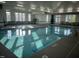 Inviting indoor swimming pool with clear blue water, large windows, and ample seating at 937 Baldwin Ridge Rd, Apex, NC 27523