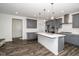 Modern kitchen with gray cabinets, a white island, and stainless-steel appliances at 937 Baldwin Ridge Rd, Apex, NC 27523