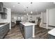 Gourmet kitchen with modern gray cabinets, stainless steel appliances, and a large island at 937 Baldwin Ridge Rd, Apex, NC 27523
