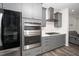 Modern kitchen featuring stainless steel oven, range and hood, and white countertops at 937 Baldwin Ridge Rd, Apex, NC 27523
