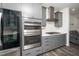 Modern kitchen featuring stainless steel oven, range and hood, and white countertops at 937 Baldwin Ridge Rd, Apex, NC 27523