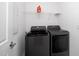 Functional laundry room with gray washer and dryer set and wire shelving at 937 Baldwin Ridge Rd, Apex, NC 27523