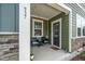 Cozy front porch with seating, a security camera, and a well-lit entryway at 937 Baldwin Ridge Rd, Apex, NC 27523