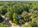 Aerial view of home nestled among lush trees offering a private and serene setting in a desirable location at 1 Gatesway Ct, Durham, NC 27707