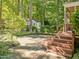 Landscaped backyard with patio, shed, and steps leading up to the house at 1 Gatesway Ct, Durham, NC 27707