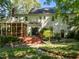 The home's beautiful backyard features a spacious screened-in porch, deck, and lush landscaping at 1 Gatesway Ct, Durham, NC 27707