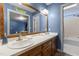 Bright bathroom featuring a double sink vanity, wood trim mirror, and separate shower and tub at 1 Gatesway Ct, Durham, NC 27707