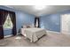 Bright bedroom with blue walls, carpet, natural light, and neutral furnishings at 1 Gatesway Ct, Durham, NC 27707
