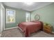 Bedroom with green walls, two windows, and a bed with a brown quilt at 1 Gatesway Ct, Durham, NC 27707