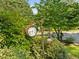 Garden clock and light fixture surrounded by lush greenery at 1 Gatesway Ct, Durham, NC 27707