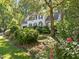 Charming home exterior with lush landscaping, mature trees and a well-maintained lawn at 1 Gatesway Ct, Durham, NC 27707