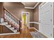 Inviting foyer features hardwood floors, a staircase with white railings, and a glimpse into an adjacent room at 1 Gatesway Ct, Durham, NC 27707