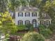 Charming two-story home boasts lush landscaping, a light blue front door, and classic black shutters at 1 Gatesway Ct, Durham, NC 27707