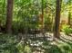 Iron gazebo amidst verdant trees offer a tranquil spot for relaxation and outdoor dining at 1 Gatesway Ct, Durham, NC 27707