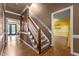 Traditional hallway with hardwood floors, staircase, and access to multiple rooms at 1 Gatesway Ct, Durham, NC 27707