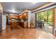 Open-plan kitchen with wood cabinets, an island, and sliding glass doors to an outdoor deck with a grill at 1 Gatesway Ct, Durham, NC 27707