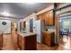 Spacious kitchen offers wood cabinets, an island, stainless steel refrigerator, and an open doorway at 1 Gatesway Ct, Durham, NC 27707