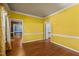 Bright living room features hardwood floors, yellow walls, and multiple doorways at 1 Gatesway Ct, Durham, NC 27707