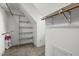 Walk-in closet with white shelves and hanging rods at 1 Gatesway Ct, Durham, NC 27707