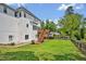 Large backyard with a wooden deck, well-maintained lawn, and privacy fence at 100 Highfield Ave, Cary, NC 27519