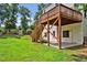 Backyard featuring a wooden deck with stairs leading down to a patio and lawn at 100 Highfield Ave, Cary, NC 27519
