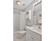 Cozy bathroom features a white shower curtain, toilet, vanity, and wall shelving at 100 Highfield Ave, Cary, NC 27519