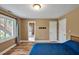 Bedroom featuring wood flooring, natural light from the window, and an ensuite bathroom at 100 Highfield Ave, Cary, NC 27519