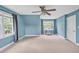 Bright bedroom featuring a ceiling fan, carpet, and natural light from large windows at 100 Highfield Ave, Cary, NC 27519