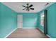 Turquoise bedroom with a ceiling fan, closet, window, and neutral carpet at 100 Highfield Ave, Cary, NC 27519