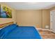 Bedroom with a blue quilt bedspread, wood flooring, and natural lighting at 100 Highfield Ave, Cary, NC 27519