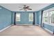 Large bedroom with carpet, natural light from multiple windows, and neutral blue paint at 100 Highfield Ave, Cary, NC 27519