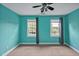 Turquoise bedroom with two windows and neutral carpet at 100 Highfield Ave, Cary, NC 27519