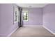 Lilac bedroom with two windows, neutral carpet, and neutral trim at 100 Highfield Ave, Cary, NC 27519
