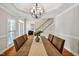 Formal dining room with hardwood floors, stylish chandelier, and staircase view at 100 Highfield Ave, Cary, NC 27519