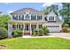 Charming two-story home with a welcoming front porch and well-manicured landscaping at 100 Highfield Ave, Cary, NC 27519
