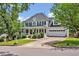 Beautiful two-story home with a covered front porch, driveway, and mature trees at 100 Highfield Ave, Cary, NC 27519