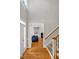 Inviting foyer featuring hardwood floors, a staircase, and a view into the living room with a fireplace at 100 Highfield Ave, Cary, NC 27519