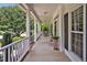 Inviting front porch with decorative columns, hanging chair, and a view of the neighborhood at 100 Highfield Ave, Cary, NC 27519
