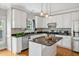Updated kitchen featuring granite countertops, stainless steel appliances, an island, and modern pendant lighting at 100 Highfield Ave, Cary, NC 27519
